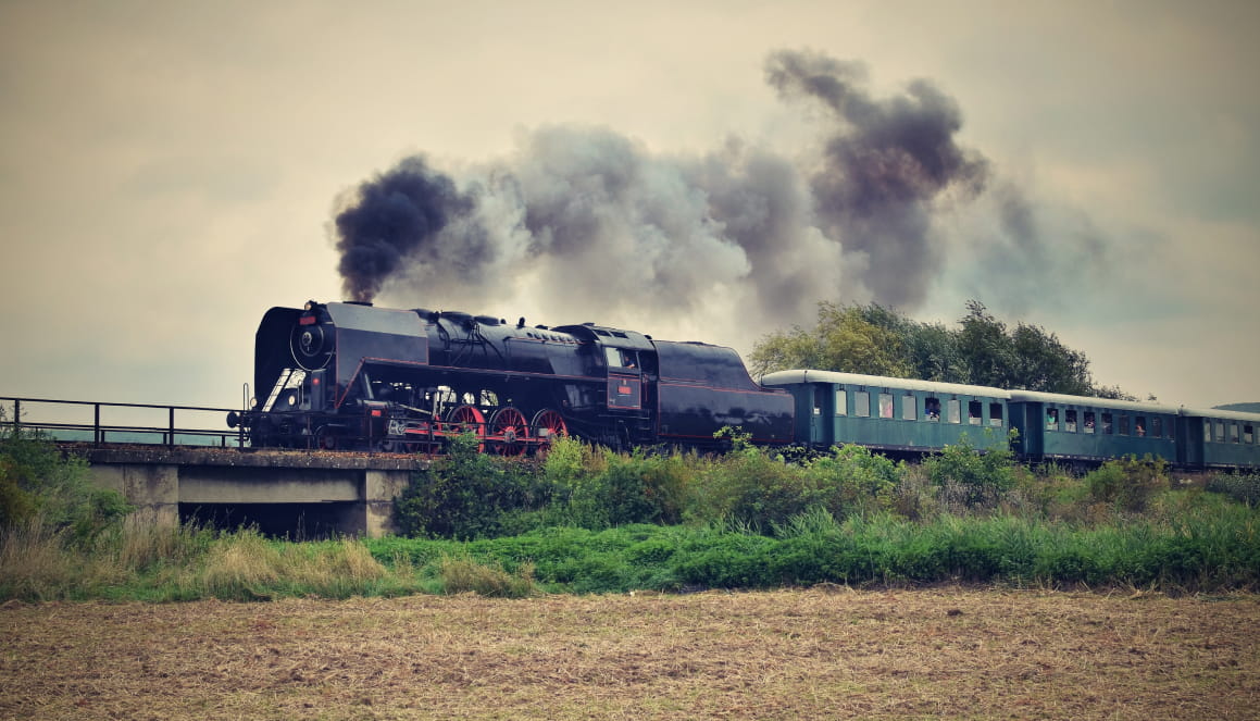 Romney Hythe and Dymchurch Railway steam train crossing Romney Marsh