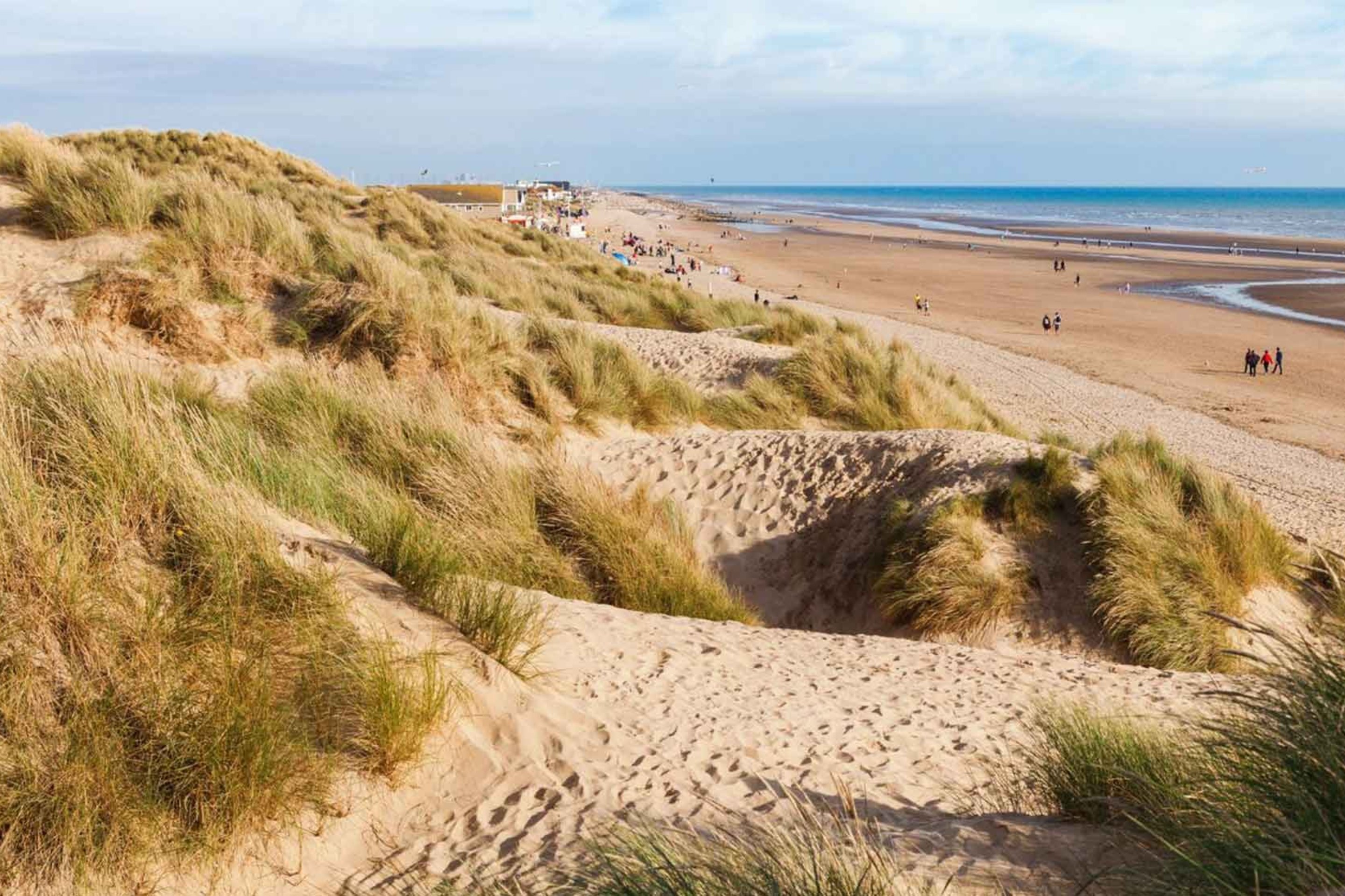 Stroll the dunes and the flat stretches on the miles of Camber Beach